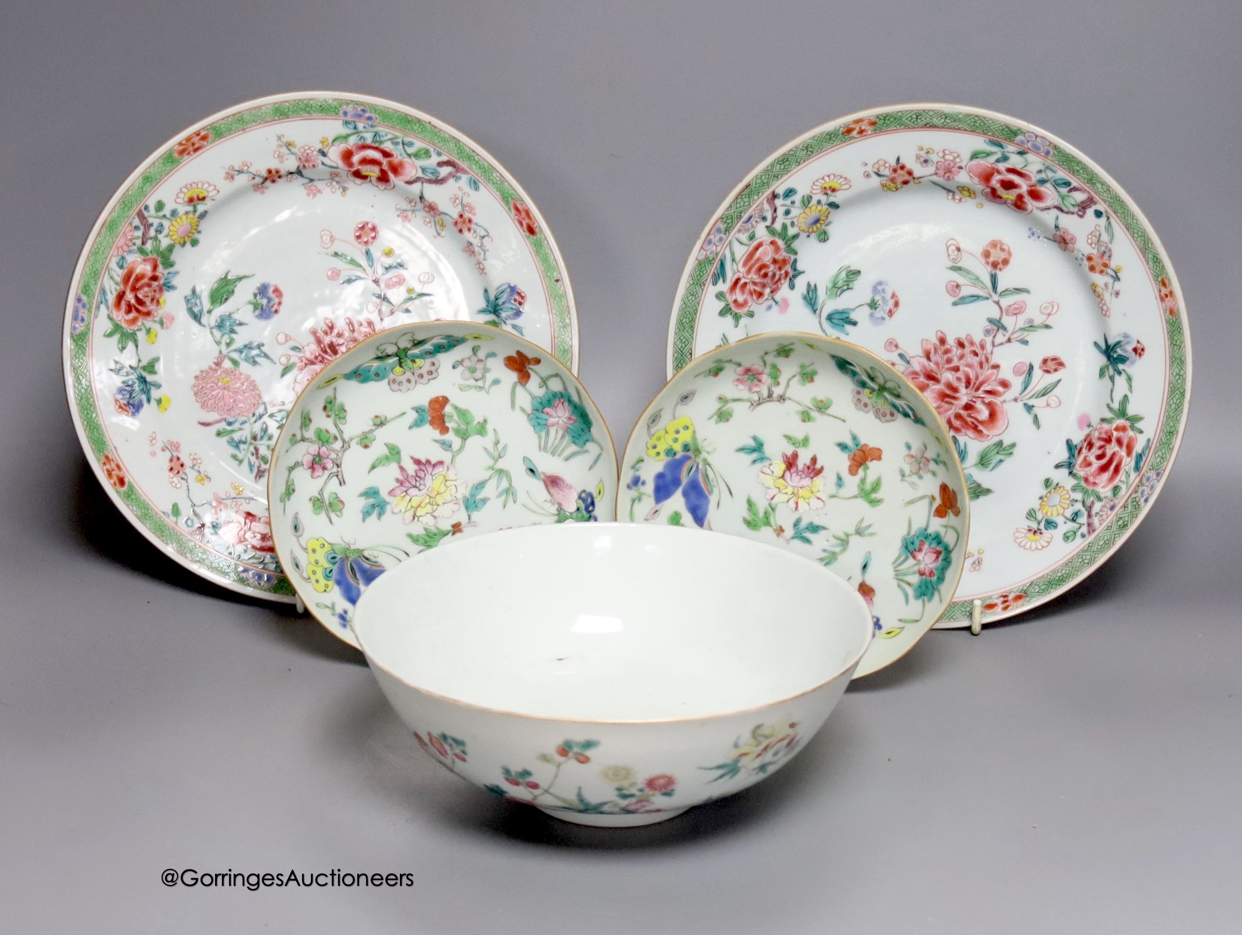 A 19th century Chinese famille rose bowl, two saucers and two 18th century Chinese famille rose plates 23cm